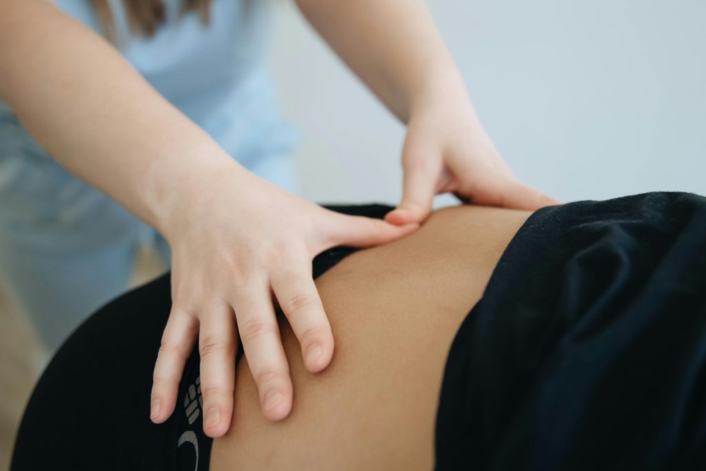Close-up of a therapist providing back massage therapy in Vilnius.